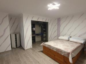 a bedroom with a bed in a room with pink and white stripes at Ferienwohnung Clausthal in Clausthal-Zellerfeld