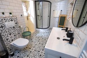 a bathroom with a white sink and a toilet at DOM na konci in Kostolné +24 photos