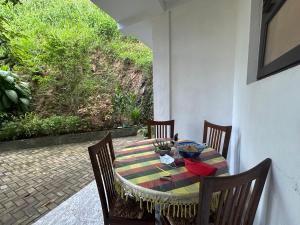 a table with chairs and a bowl of fruit on it at No 44,Anniewatte Road in Kandy