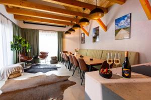 a dining room with a table and a bottle of wine at DOM na konci in Kostolné