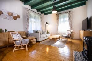 a living room with a couch and a tv at DOM na konci in Kostolné