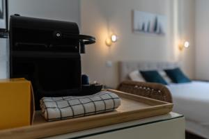 a sewing machine sitting on a table in a bedroom at Chambre 5 La Baieta in Nice +2 photos