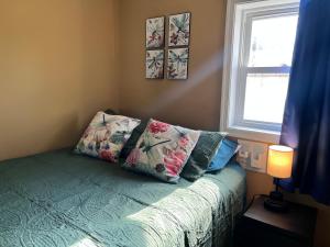 a bedroom with a bed with pillows and a window at The Bay House in Shady Side