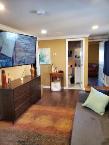 a living room with a large flat screen tv at The Bay House in Shady Side