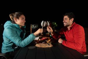 a man and a woman sitting at a table with a plate of food at DM El Refugio SG B2 in Pinal de Amoles