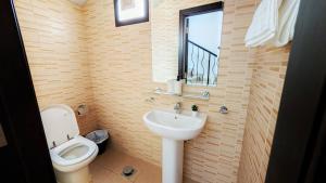 a bathroom with a sink and a toilet and a window at Family Friendly Villa in Abu Dhabi