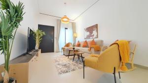 a living room with a couch and a table at Family Friendly Villa in Abu Dhabi
