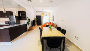 a dining room and kitchen with a table and chairs at Family Friendly Villa in Abu Dhabi +8 photos