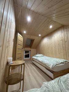 a bedroom with a bed and a wooden ceiling at Mazurski Chill House in Małkinie