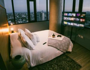 a bedroom with a bed with a view of a city at Volcano View Loft, Puebla Skyline1801 in Puebla