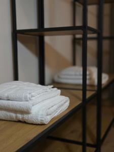 a stack of towels on a shelf in a room at Tilly's Locanda in Borso del Grappa