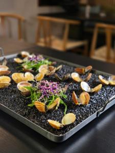 a tray of food with mushrooms and vegetables on it at Tilly's Locanda in Borso del Grappa