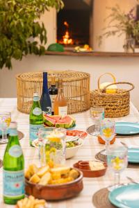 a table with plates of food and bottles of wine at Finca Can Rosa Ibiza, private pool, a nature getaway in Santa Gertrudis de Fruitera
