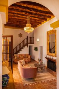 a living room with a couch and a chandelier at Finca Can Rosa Ibiza, private pool, a nature getaway in Santa Gertrudis de Fruitera
