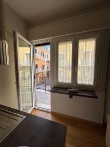 an empty room with two windows and a balcony at Fortunato Casa Vacanze in Matera +14 photos