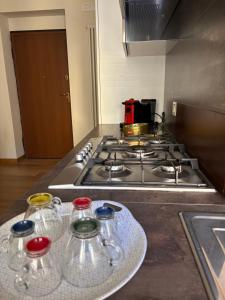 a kitchen with a stove with glasses on a counter at Fortunato Casa Vacanze in Matera