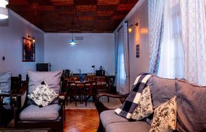 a living room with a couch and a dining room table at AG Comfort Homes in Nkunjila