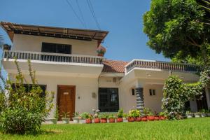 a large white house with a green yard at AG Comfort Homes in Nkunjila