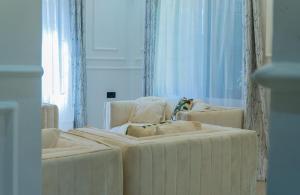 a living room with two white chairs and a couch at AG Comfort Homes in Nkunjila +91 photos