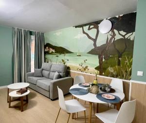 a living room with a painting on the wall at Luxury Singular Apartments Padrón in Padrón