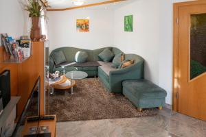a living room with a couch and a chair at dastraunseehaus in Traunkirchen +11 photos