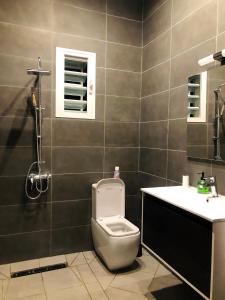 a bathroom with a toilet and a sink at Maison d'hôte Chez Vané in Sambava +23 photos
