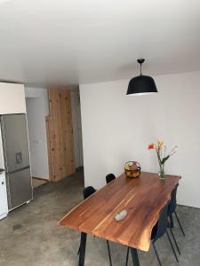 a wooden table in a room with a kitchen at Casa Picobello in Calheta de Nesquim +18 photos