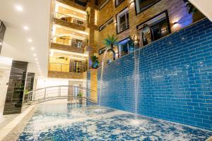 a hot tub in a building with blue tiles at P Quattro Relax Hotel in Wadi Musa