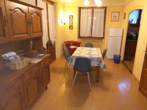 a kitchen with a table and chairs and a refrigerator at morel in Cluses
