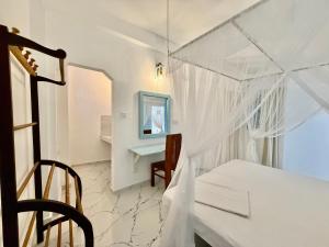 a white room with a table and a desk at Shells Unawatuna in Unawatuna