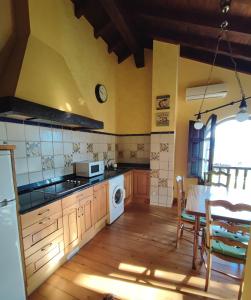 a kitchen with a table and a stove top oven at Apartamentos El Caballar in Sandoñana
