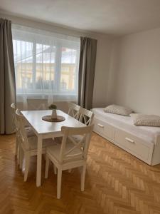 a bedroom with a dining table and a bed at Litovelské apartmány in Litovel +52 photos