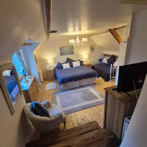 a living room with a bed and a couch at The Millers Cottage in Okehampton