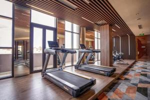 a gym with three tread machines in a room at Apec Mandala Ocean Retreat- Mui Ne in Mui Ne