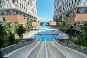 a swimming pool in the middle of a building at Apec Mandala Ocean Retreat- Mui Ne in Mui Ne