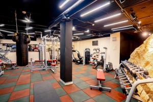 a gym with several tread machines and weights at P Quattro Relax Hotel in Wadi Musa