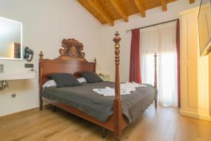 a bedroom with a large bed with a wooden headboard at TI Central Maria in Maria de la Salut
