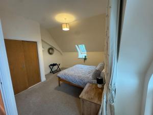 a bedroom with a bed and a wooden door at Turfhill House in New Deer