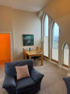a living room with a couch and a table at Turfhill House in New Deer
