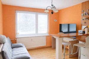 a living room with a desk and a computer at Apartmán Levice in Levice