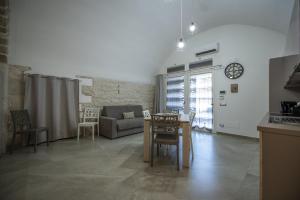 a living room with a table and a couch at La Lanterna in Giovinazzo