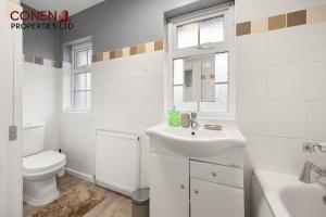 a white bathroom with a sink and a toilet at CONEN Morant Place in Grays Thurrock +11 photos