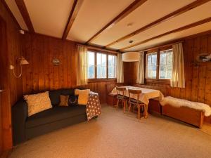 a living room with a couch and a table at Charming Chalet Silvretta in Flumserberg in Flums