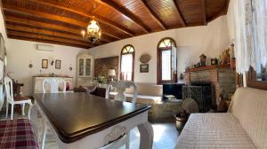a living room with a table and a fireplace at Sea View Traditional Villa in Vourvourou +86 photos