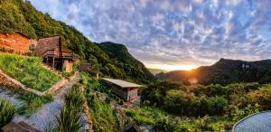 a house on a hill with the sunset in the background at DM El Refugio SG B2 in Pinal de Amoles +58 photos