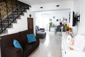 a living room with a couch and a staircase at Casa 'Saudade' in Moura