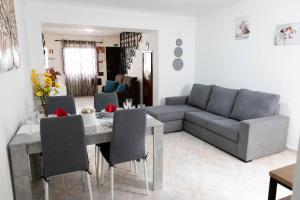 a living room with a couch and a table with chairs at Casa 'Saudade' in Moura