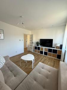 a living room with a couch and a table at AgA in Pobierowo