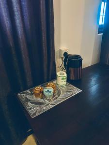 a table with two candles on top of it at Asiri guest house in Dickwella