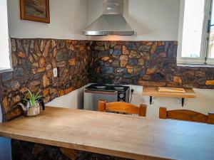 a kitchen with a wooden table and a stove at Armaki in Páliros +21 photos